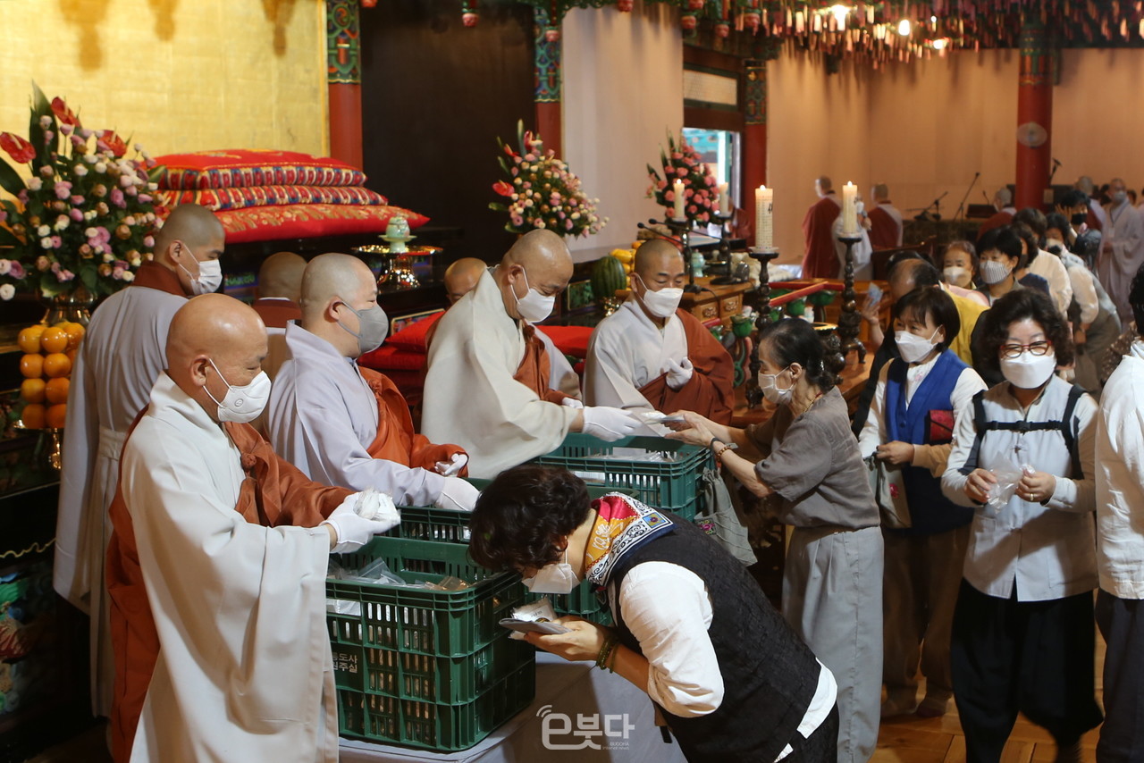 주지 현문 스님을 비롯한 소임자 스님들이 불자들에게 소금 봉투를 나눠주고 있다.